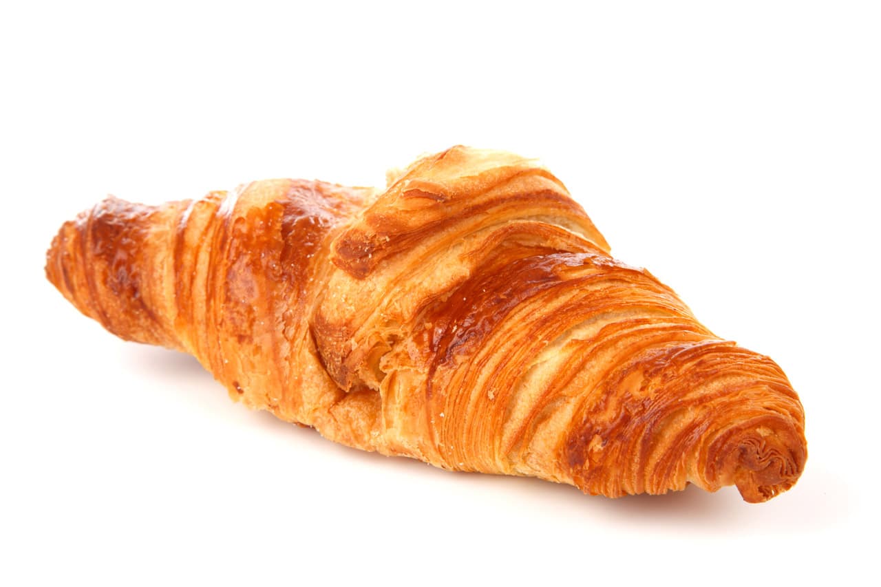 A golden croissant on a white background